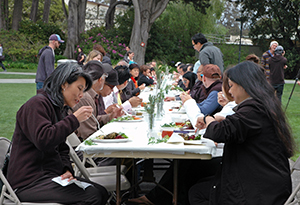A photo of people eating lunch on the quad during Farm to Fork 2014.